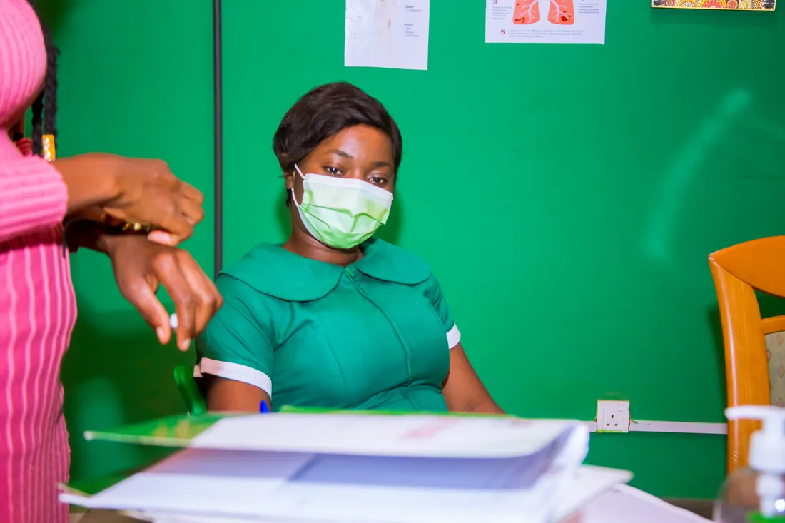 A MAON nurse at the OPD desk, with a patient's file in front of her.