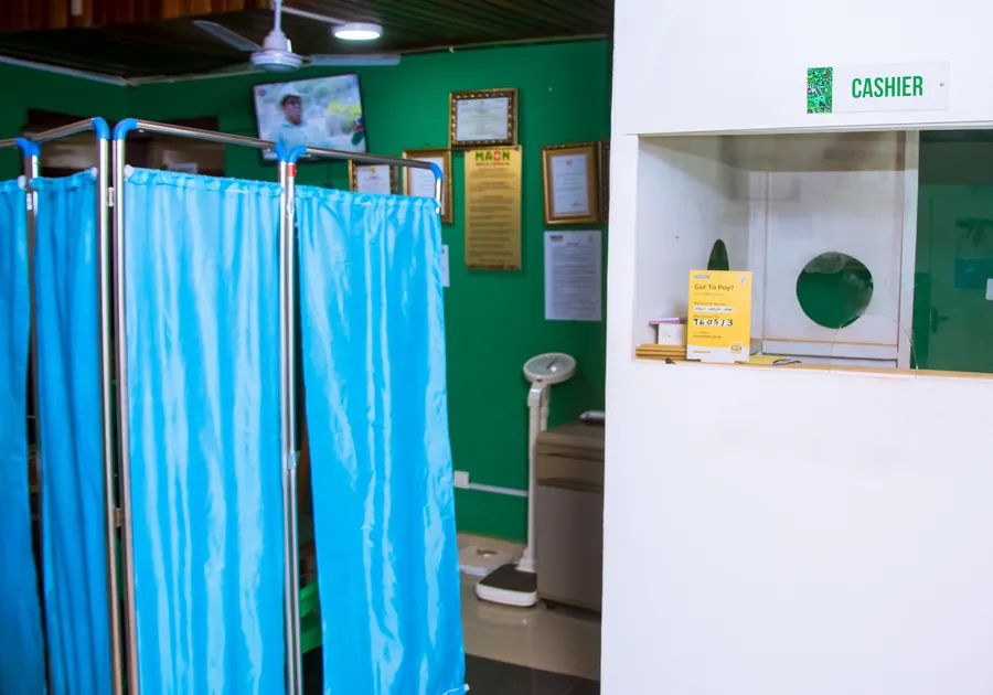 The OPD screening area at MAON, with curtained bays and a weighing scale.