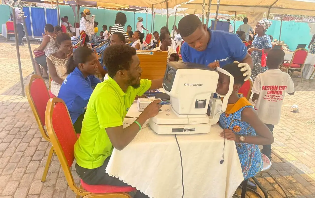 A MAON health worker doing a free eye screening for a girl at a community outreach.
