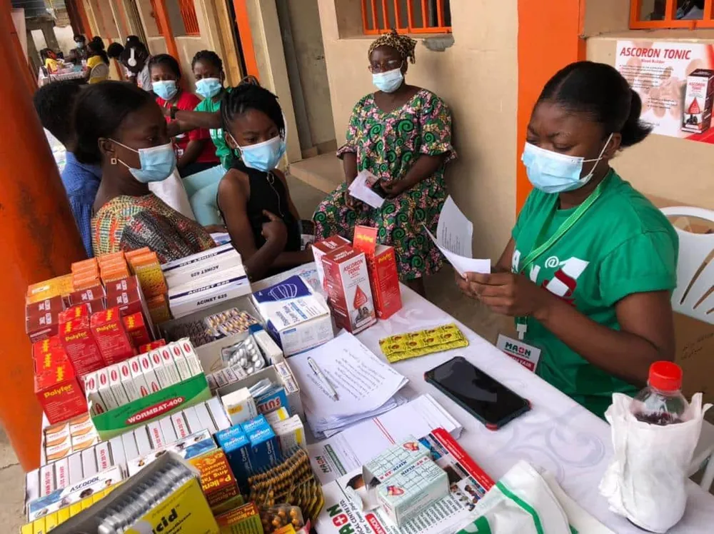 A MAON health worker at the outreach dispensary table.