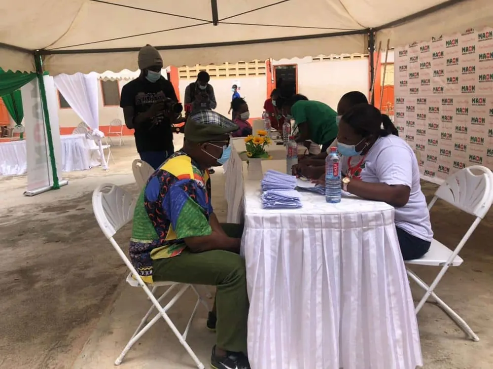 MAON health workers screening community members under a tent.